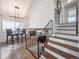Open staircase with iron railing leading to an eat-in nook with great natural light at 9667 W Ohio Ave, Lakewood, CO 80226