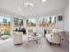 Bright and airy sun room featuring comfortable seating and backyard views at 9667 W Ohio Ave, Lakewood, CO 80226