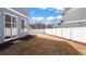 Backyard with slider door, white vinyl fence and minimal tree coverage at 20801 Randolph Pl, Denver, CO 80249