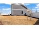 Backyard featuring gray siding, minimal landscaping, and a white vinyl fence at 20801 Randolph Pl, Denver, CO 80249