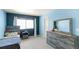 Comfortable bedroom with gray wood furnishings, colorful decor and bright window at 20801 Randolph Pl, Denver, CO 80249