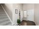 Inviting entryway featuring hardwood floors, a staircase, and natural light from the front door window at 20801 Randolph Pl, Denver, CO 80249