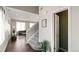 Open entryway with staircase, hardwood floors, a glimpse of the living area, and a conveniently located powder room at 20801 Randolph Pl, Denver, CO 80249
