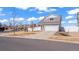 Charming two-story home with gray siding, attached two-car garage, and well-maintained landscaping at 20801 Randolph Pl, Denver, CO 80249