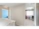 Upstairs hallway leads to bedrooms and office space with ample light and a neutral color palette at 20801 Randolph Pl, Denver, CO 80249