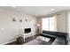 Cozy living room featuring dark wood floors, modern furnishings, large window, and a stylish striped rug at 20801 Randolph Pl, Denver, CO 80249