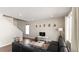 Bright living area with hardwood floors, modern furnishings, large window, and staircase at 20801 Randolph Pl, Denver, CO 80249