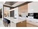 Modern kitchen with white and wood cabinets, large island, and high-end appliances at 1901 Wazee St # 1401, Denver, CO 80202