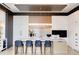 Modern kitchen with white and wood cabinets, large island, and high-end appliances at 1901 Wazee St # 1401, Denver, CO 80202