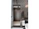 Walk-in shower with dark tile and glass enclosure at 1901 Wazee St # 1401, Denver, CO 80202