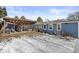 Large backyard with covered patio area and a combination of grass and snow at 2717 S Steele St, Denver, CO 80210