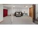 Finished basement area with carpet, a couch, and a play area with a red cabinet at 2717 S Steele St, Denver, CO 80210