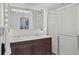 Bright bathroom features double sink, dark wood vanity, and a glass enclosed shower at 2717 S Steele St, Denver, CO 80210