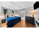 Inviting bedroom featuring hardwood floors, a plush bed, and modern accents for a peaceful retreat at 2717 S Steele St, Denver, CO 80210
