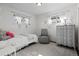 Bright bedroom with white walls, neutral decor, and a large window allowing natural light to fill the room at 2717 S Steele St, Denver, CO 80210