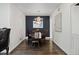 Formal dining room with dark walls, elegant chandelier, and hardwood floors at 2717 S Steele St, Denver, CO 80210