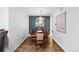 Formal dining room with dark wood table, chandelier, and an accent wall at 2717 S Steele St, Denver, CO 80210