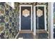 Entryway with mirrored closet doors and decorative floral wallpaper featuring pineapples at 2717 S Steele St, Denver, CO 80210