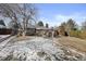 Wide front yard view with mature trees and a brick fence enclosing the space at 2717 S Steele St, Denver, CO 80210