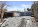 Attached garage with carport and additional storage space, set against a snowy backdrop at 2717 S Steele St, Denver, CO 80210