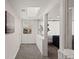 Bright hallway with skylight and a view of the living room through a large window at 2717 S Steele St, Denver, CO 80210