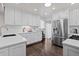 Modern kitchen features white cabinets, stainless steel fridge, and subway tile backsplash at 2717 S Steele St, Denver, CO 80210