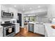 Well-lit kitchen features stainless steel appliances, sleek countertops, and seamless transition to the living area at 2717 S Steele St, Denver, CO 80210