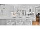 Bright, all-white kitchen featuring stainless steel appliances and a center island with seating at 2717 S Steele St, Denver, CO 80210