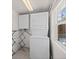 Bright laundry room with washer/dryer combo, cabinets, drying rack, and natural light at 2717 S Steele St, Denver, CO 80210