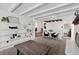 Cozy living room with beamed ceiling, a large shelving unit, and a fireplace at 2717 S Steele St, Denver, CO 80210