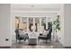 Bright living room featuring a bay window, two armchairs, and stylish decor in a neutral color palette at 2717 S Steele St, Denver, CO 80210