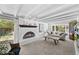 Cozy living room with a fireplace, exposed beams, and a large window for natural light at 2717 S Steele St, Denver, CO 80210