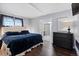 Elegant main bedroom with a dark wood dresser and an ensuite bathroom at 2717 S Steele St, Denver, CO 80210