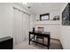 Simple home office with a small window and a black wooden desk and chair at 2717 S Steele St, Denver, CO 80210