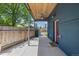 Covered back patio with stylish wooden ceiling, offering an inviting outdoor space for relaxation and entertaining guests at 2577 Depew St, Edgewater, CO 80214