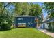Lush backyard view featuring a well-maintained lawn, mature trees, and private patio offering a serene outdoor retreat at 2577 Depew St, Edgewater, CO 80214
