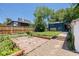 Expansive backyard with stone patio, well-manicured garden beds, and lush lawn creating a serene outdoor oasis at 2577 Depew St, Edgewater, CO 80214