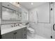 Modern bathroom with marble tiled wall, stylish vanity, sleek fixtures, and glass-enclosed shower at 2577 Depew St, Edgewater, CO 80214