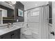 Classic bathroom with black and white tile, vintage-style fixtures, and a soaking tub at 2577 Depew St, Edgewater, CO 80214