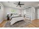 Bright bedroom with large windows, ceiling fan, hardwood floors and an en-suite bathroom at 2577 Depew St, Edgewater, CO 80214