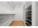 Well-organized walk-in closet with ample storage space and built-in shelving and hardwood floors at 2577 Depew St, Edgewater, CO 80214