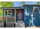 Close-up of blue home with decorative star, modern porch railing, and vibrant red front door at 2577 Depew St, Edgewater, CO 80214