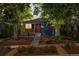Charming home with a cozy front porch, stylish planters, and a walkway framed by colorful flower beds at 2577 Depew St, Edgewater, CO 80214