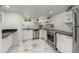Contemporary kitchen features stainless steel appliances, sleek countertops, and bright backsplash, offering a stylish cooking space at 2577 Depew St, Edgewater, CO 80214
