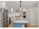 Contemporary kitchen featuring stainless steel appliances, a large island, and ample counter space at 2577 Depew St, Edgewater, CO 80214