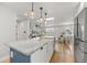 Bright and open kitchen featuring a spacious island, stainless steel appliances, and seamless access to living spaces at 2577 Depew St, Edgewater, CO 80214