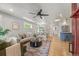 Bright, open living room with hardwood floors, stylish furniture, and an open floor plan at 2577 Depew St, Edgewater, CO 80214