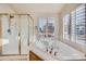 Bright bathroom showcases shower, tub, and shuttered window for natural light at 3938 Lazy K Dr, Castle Rock, CO 80104