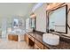 Elegant bathroom featuring double sinks, granite counters, a soaking tub, and a shower at 3938 Lazy K Dr, Castle Rock, CO 80104