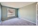 Bedroom with carpet flooring, neutral walls, trim and a large window to view outside at 3938 Lazy K Dr, Castle Rock, CO 80104